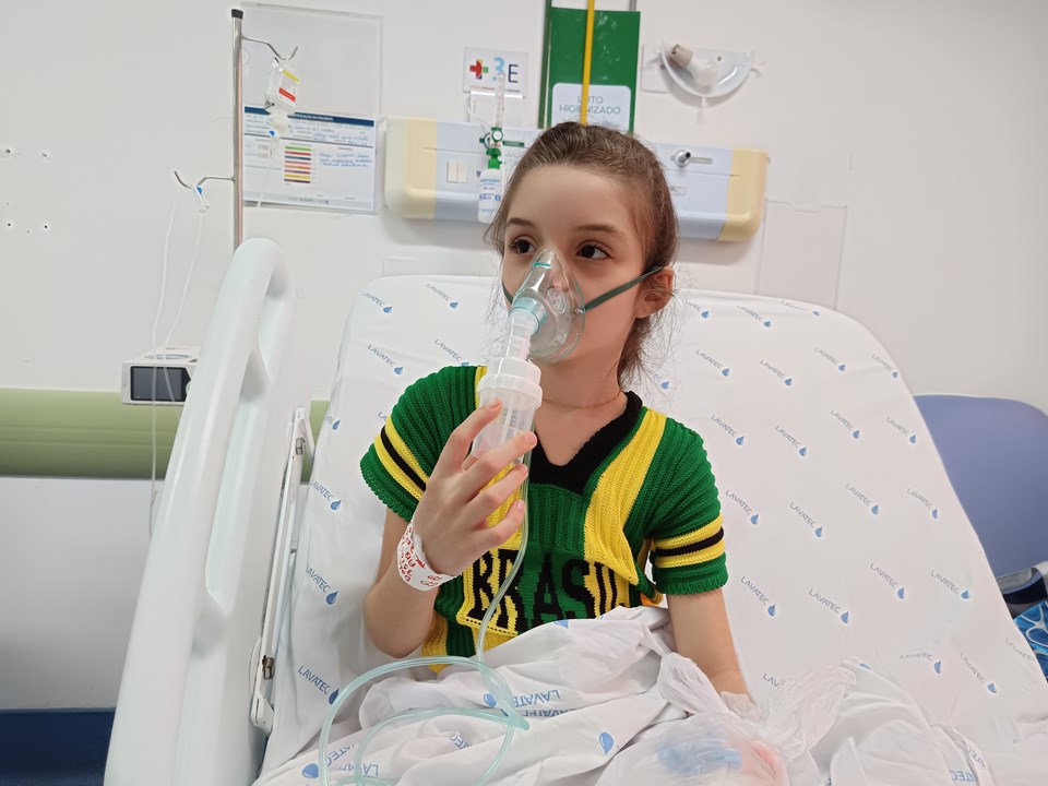 Consulta médica pediátrica com especialista examinando a respiração de uma criança pequena para identificar sintomas de infecção respiratória.